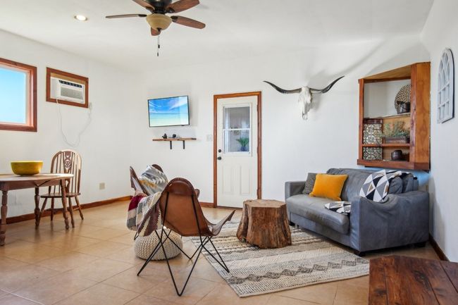 View of the farmhouse interior with door to the back porch at your back. | Image 4