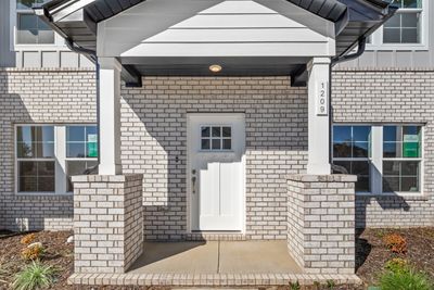 The front porch is covered & has loads of curb appeal. | Image 2