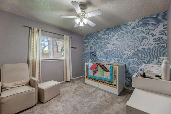 Carpeted bedroom with a textured ceiling and ceiling fan | Image 10