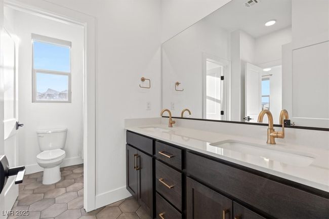 Full bathroom featuring toilet, tile patterned flooring, double vanity, and a sink | Image 43