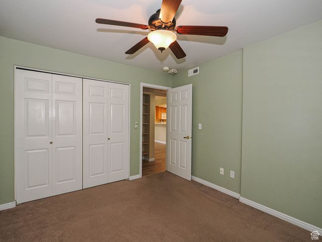 Unfurnished bedroom featuring baseboards, visible vents, a closet, ceiling fan, and carpet floors | Image 16