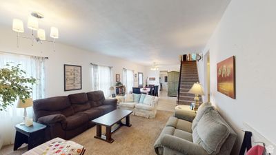 Living room featuring an inviting chandelier and carpet flooring | Image 2