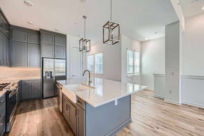 Kitchen featuring light quartz countertops, stainless steel appliances, and light wood finished floors | Image 20