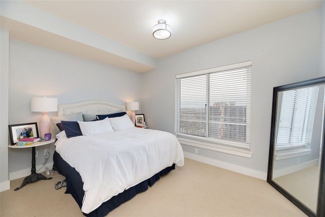 Bedroom with multiple windows and carpet flooring | Image 14