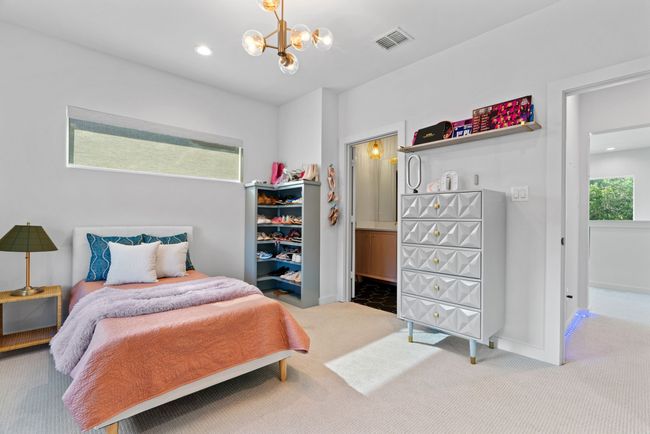Carpeted bedroom with a chandelier, recessed lighting, and ensuite bathroom | Image 31