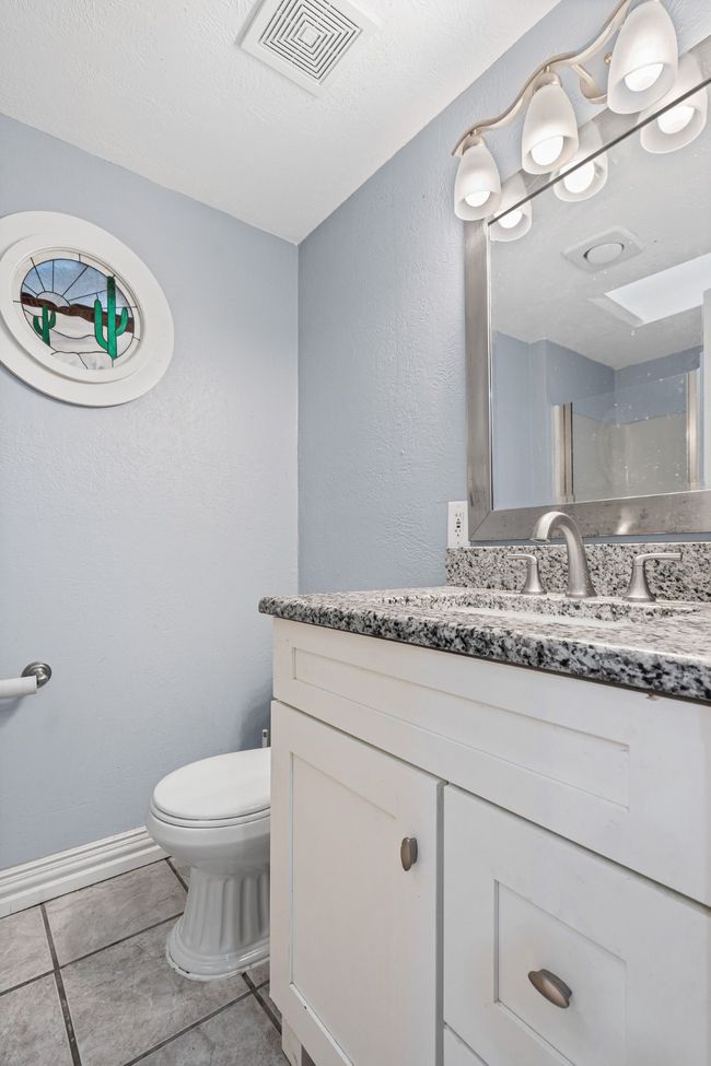 Bathroom with vanity, tile patterned floors, and a shower | Image 26