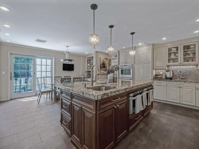 Kitchen with a sink, crown molding, backsplash, glass insert cabinets, and recessed lighting | Image 9