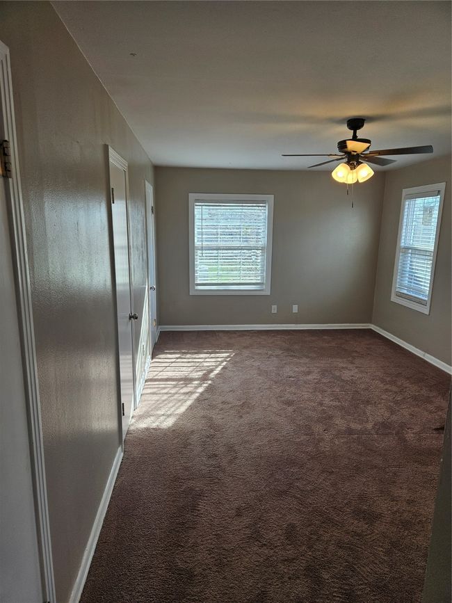Carpeted spare room featuring a wealth of natural light and baseboards | Image 6