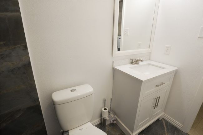 Bathroom with vanity, toilet, and baseboards | Image 15