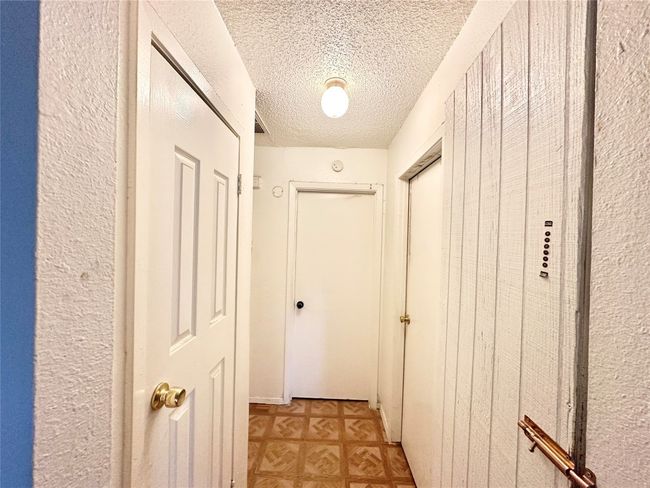 Hallway featuring a textured ceiling | Image 11