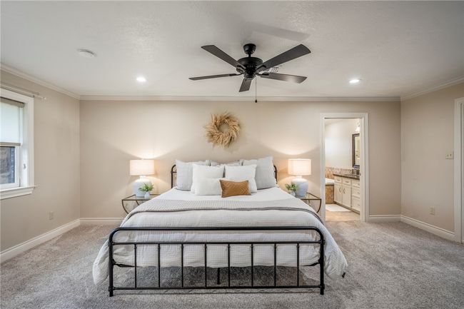 Bedroom featuring light carpet, baseboards, crown molding, and recessed lighting | Image 32