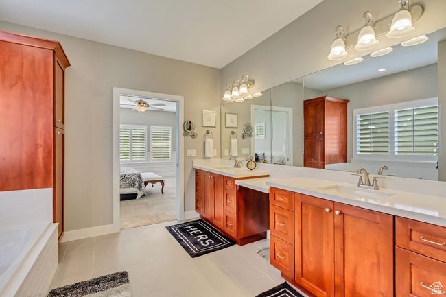 Full bath with a ceiling fan, a sink, ensuite bathroom, and double vanity | Image 17