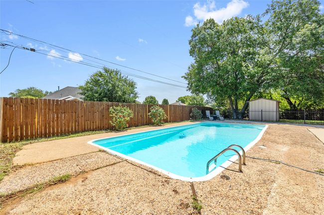 View of swimming pool featuring a fenced backyard | Image 33