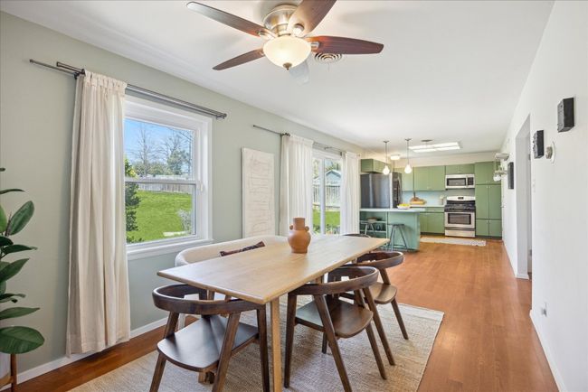 Dining space with light wood-type flooring, baseboards, and a ceiling fan | Image 12