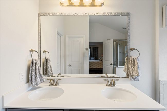 Bathroom featuring a shower stall, double vanity, ensuite bath, and a sink | Image 17