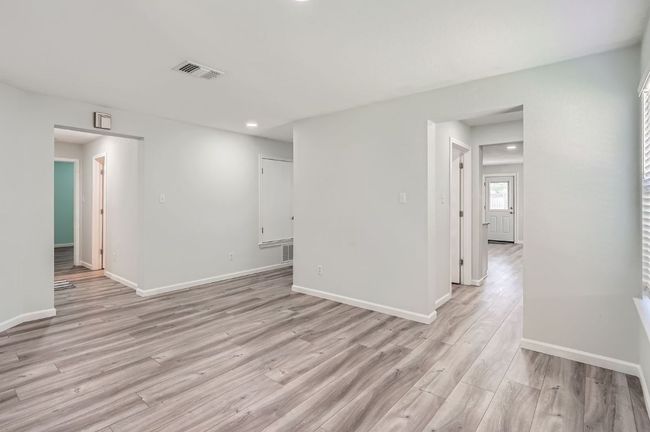 Unfurnished room featuring light wood-style flooring, baseboards, visible vents, and recessed lighting | Image 10