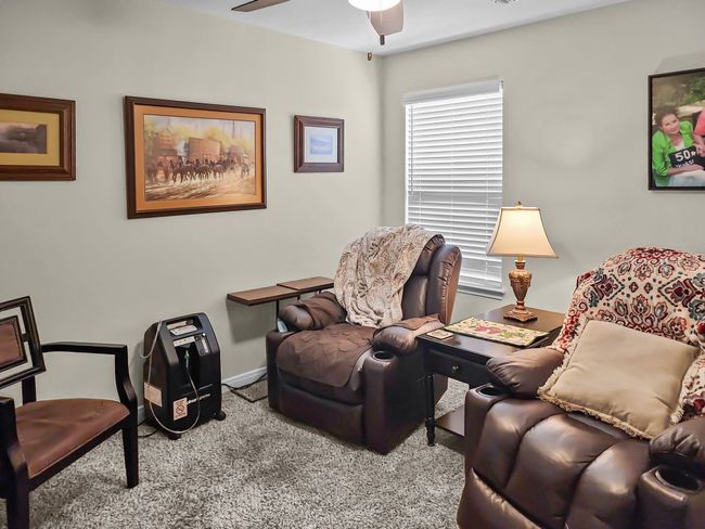 bedroom 2 with carpet, a ceiling fan, and an office area | Image 26