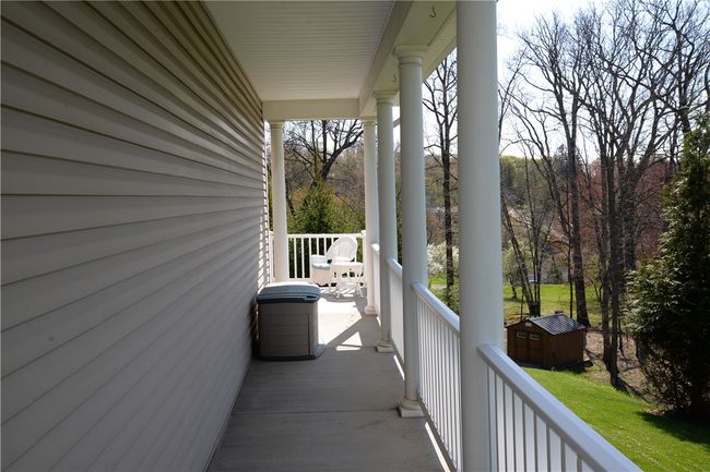 The front porch wraps all the way around to the back patio. Simply perfect! | Image 44