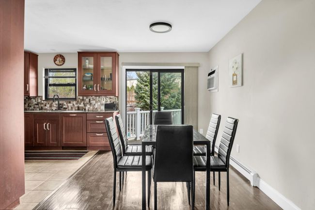 Dining room featuring a baseboard heating unit, plenty of natural light, light wood-style flooring, and baseboards | Image 5