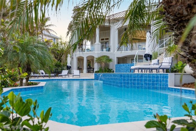 View of pool with pool water feature and a patio area | Image 23