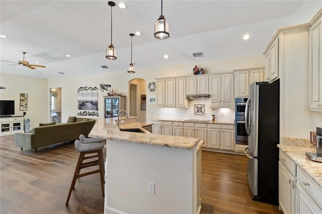 Pendant lights over 3cm granite countertops, raised panel 42" cabinets &tumble marbled backsplash. | Image 10