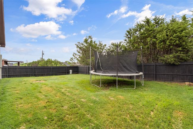 Fenced backyard with a trampoline | Image 37