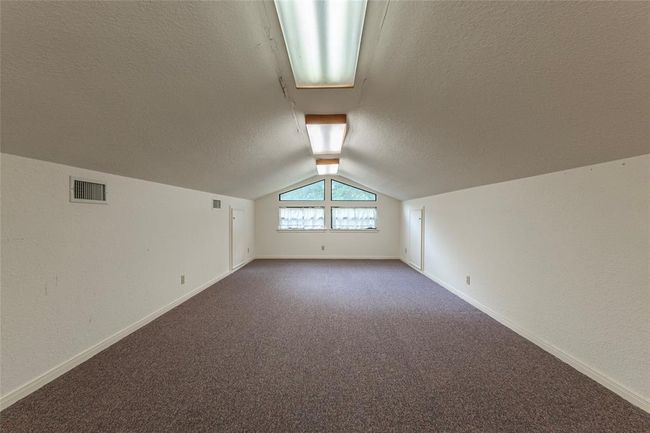 Loft area for additional sleeping space or game room above the garage at main house | Image 24