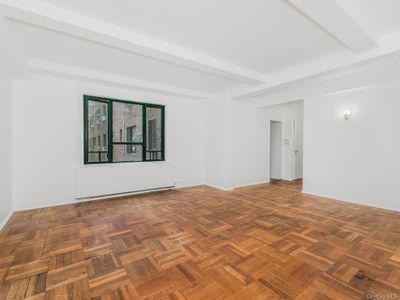 Spare room featuring parquet floors and beamed ceiling | Image 2