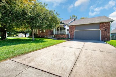 View of front of house with a front yard, a porch, and a garage | Image 2