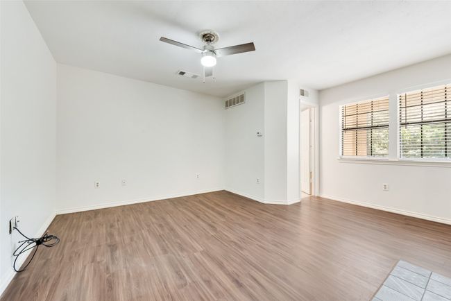 Spare room featuring wood finished floors and ceiling fan | Image 18