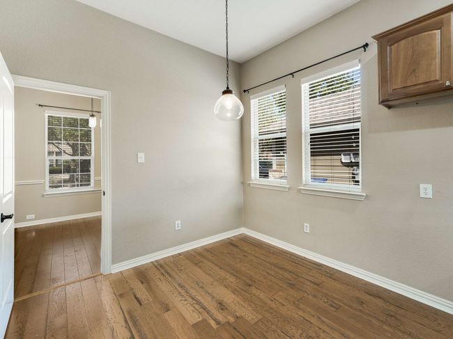 Unfurnished dining area with wood finished floors and baseboards | Image 7