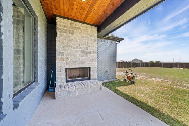 Exterior Stone fireplace for those chilly nights on the patio. | Image 33