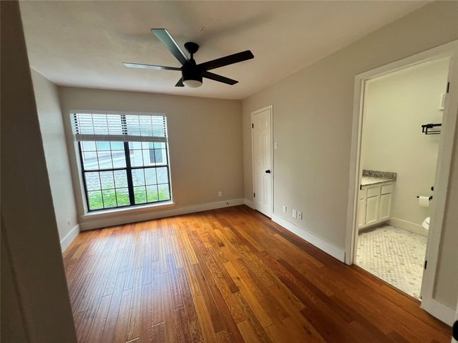 Unfurnished room featuring wood-type flooring, ceiling fan, and baseboards | Image 22