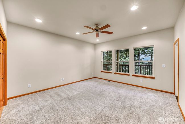 Third very large bedroom downstairs with access to the deck | Image 27