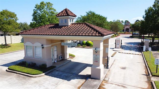 This is a secure gated community entrance featuring a guardhouse and controlled access gates provide the safety and security most residence enjoy in this 55+ community. | Image 32