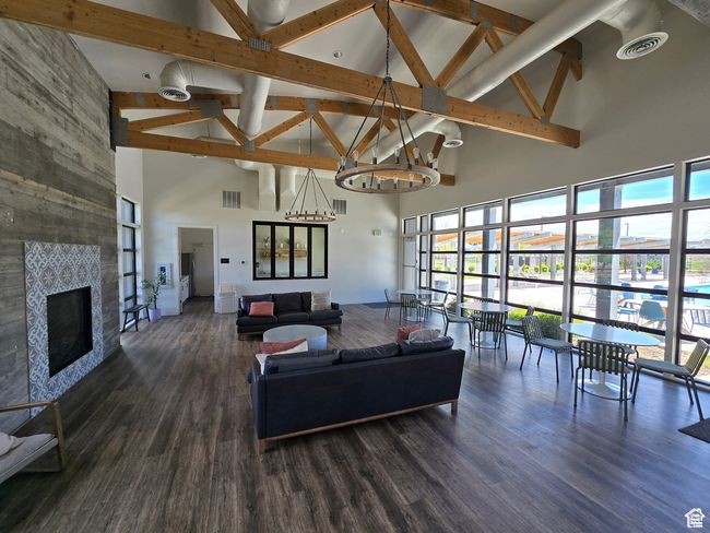 Living room featuring high vaulted ceiling, healthy amount of natural light, beamed ceiling, a chandelier, and baseboards | Image 25