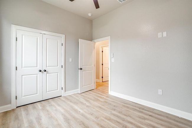 Unfurnished bedroom featuring a ceiling fan, baseboards, light wood finished floors, and a closet | Image 28