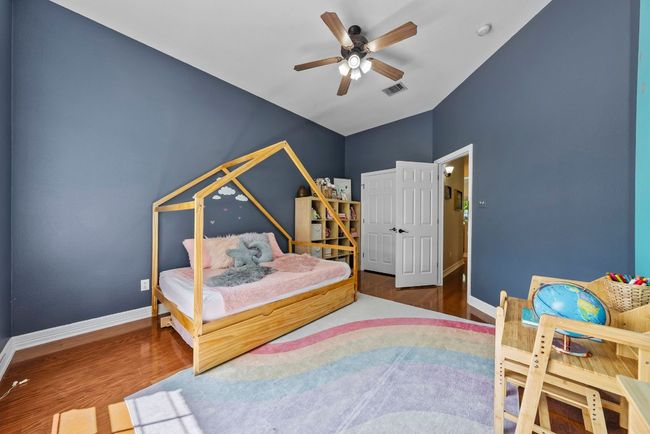 Secondary bedrooms have ceiling fans, hardwood flooring & roomy closets | Image 19