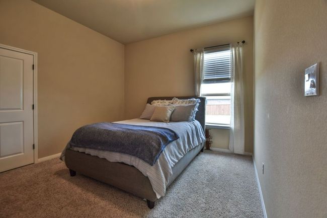 Carpeted bedroom with baseboards | Image 18