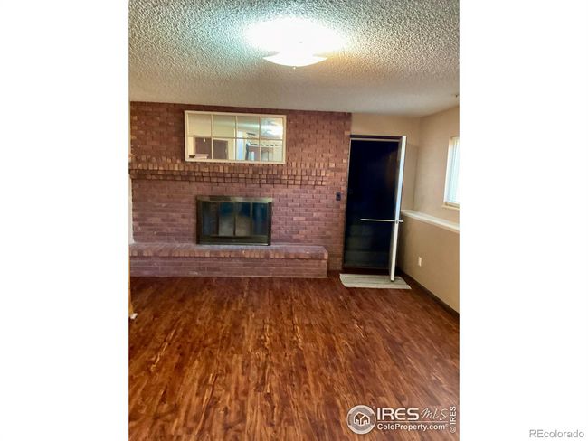 Fireplace in Lower Level Family Room with Access to Garage | Image 9