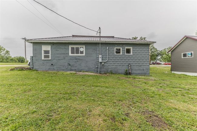 View of side of property with a yard and metal roof | Image 42