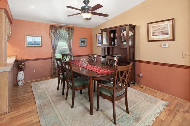 Dining space with ceiling fan, light wood finished floors | Image 13