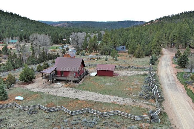 Birds eye view of property featuring a forest view and a mountain view | Image 52