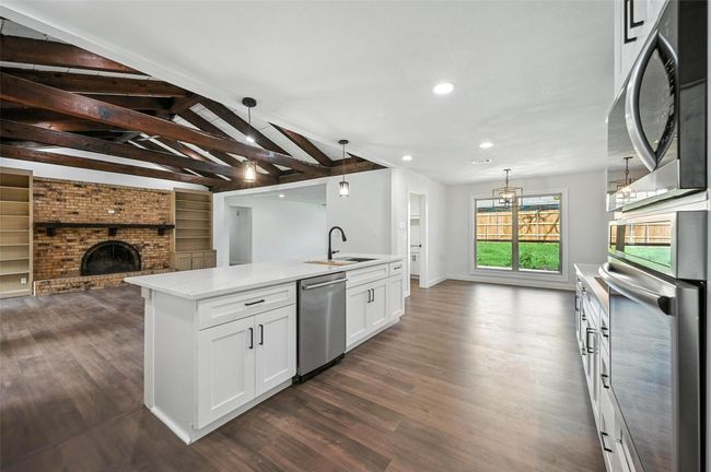 Modern kitchen opens directly into the living room. | Image 5