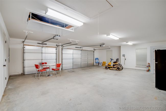 HUGE garage. Strom safe room is tucked away in the corner and doesn't impede parking 3 cars in the garage | Image 31