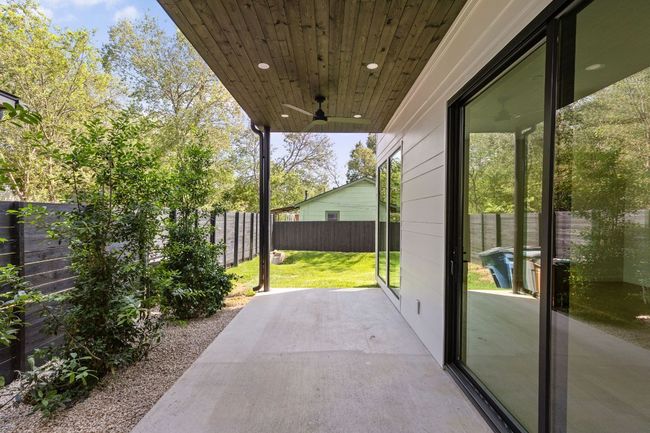 Fenced backyard featuring a ceiling fan and a patio area | Image 15