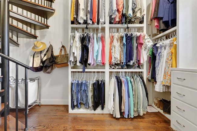 The suite is further enhanced by his and her walk-in closets, both outfitted with custom built-ins for optimal organization. | Image 26