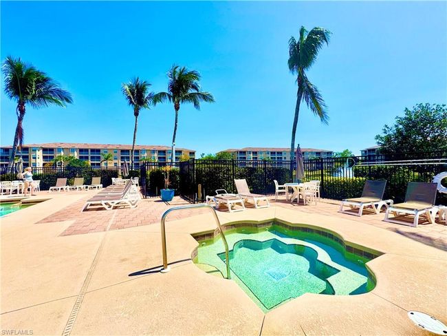 View of pool with a patio, a hot tub, and fence | Image 30