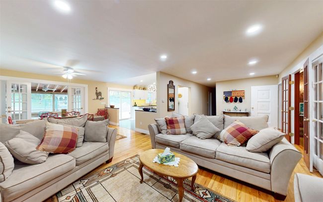 Living room featuring light wood-style floors, french doors, recessed lighting, and ceiling fan | Image 10