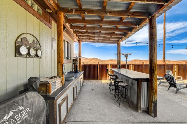 Fenced backyard with a patio area | Image 39